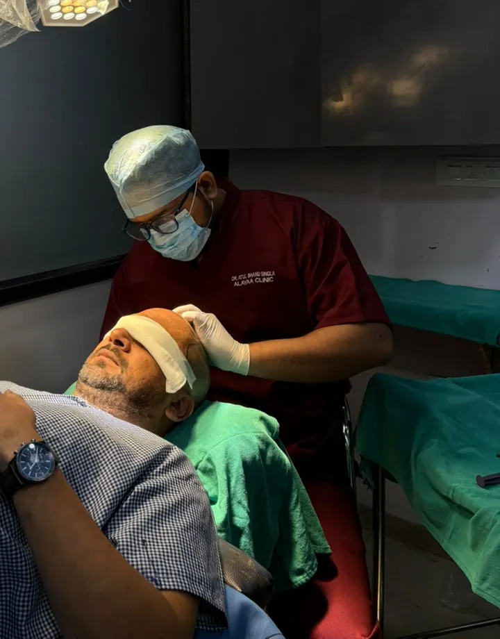 Dr. Atul checking a patient's scalp before the procedure