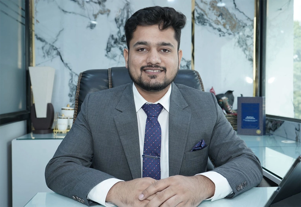 Dr. Atul Bhanu Singla seated at his desk